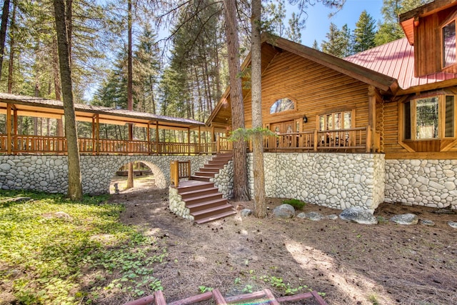 1062 Bear Creek Trl, Victor, MT 59875 - view of home's exterior with stairway, a metal roof, and a wooden deck