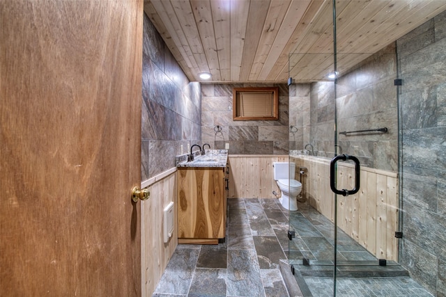1062 Bear Creek Trl, Victor, MT 59875 - bathroom with stone tile floors, vanity, tile walls, and wood ceiling