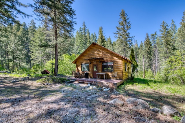 1062 Bear Creek Trl, Victor, MT 59875 - view of front of house with a forest view and a deck