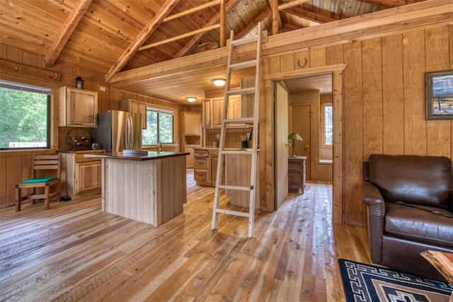 1062 Bear Creek Trl, Victor, MT 59875 - kitchen featuring freestanding refrigerator, wood walls, a wooden ceiling with exposed beams, light wood finished floors, and plenty of natural light