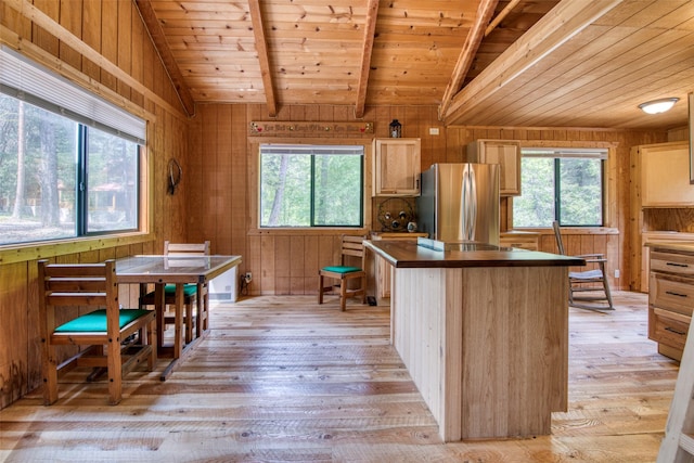 1062 Bear Creek Trl, Victor, MT 59875 - kitchen with freestanding refrigerator, wood ceiling, plenty of natural light, light wood-type flooring, and wooden walls