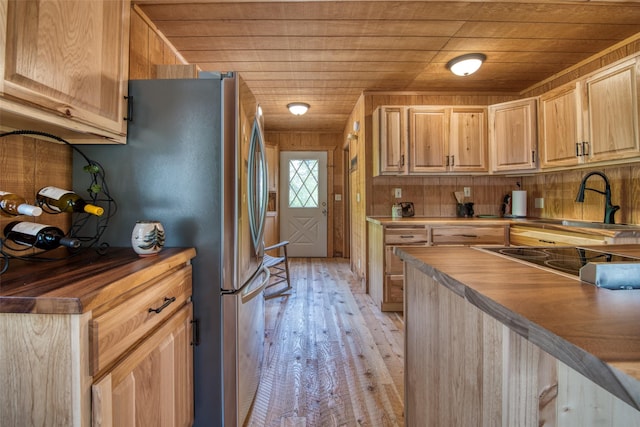 1062 Bear Creek Trl, Victor, MT 59875 - kitchen featuring wooden ceiling, butcher block countertops, light wood-type flooring, light brown cabinets, and freestanding refrigerator