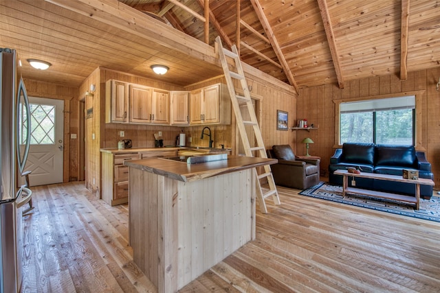 1062 Bear Creek Trl, Victor, MT 59875 - kitchen featuring wood ceiling, freestanding refrigerator, light wood-style floors, open floor plan, and wooden walls