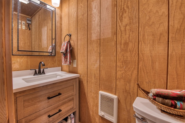 1062 Bear Creek Trl, Victor, MT 59875 - bathroom featuring vanity, heating unit, and wooden walls