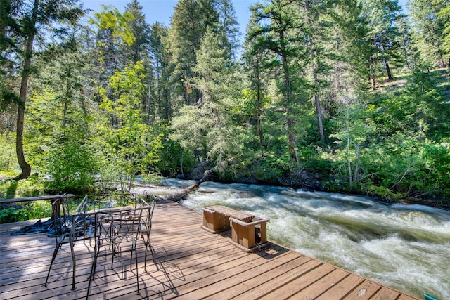 1062 Bear Creek Trl, Victor, MT 59875 - deck featuring outdoor dining area and a wooded view