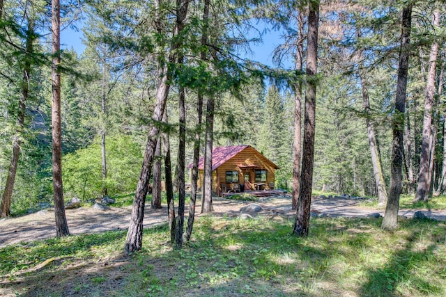 1062 Bear Creek Trl, Victor, MT 59875 - view of yard featuring a porch and a view of trees