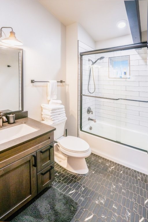 1331 Nelson Lane Cabins H & I, Whitefish, MT 59937 - bathroom featuring vanity, combined bath / shower with glass door, and toilet