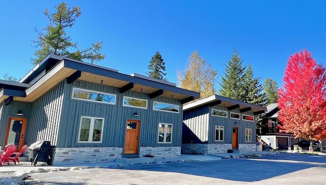 1331 Nelson Lane Cabins H & I, Whitefish, MT 59937 - view of front of property featuring board and batten siding and stone siding