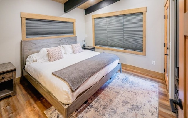1331 Nelson Lane Cabins H & I, Whitefish, MT 59937 - bedroom featuring wood finished floors, beam ceiling, and baseboards