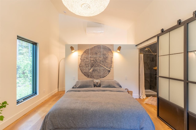 135 Gamma Rd, Hungry Horse, MT 59919 - bedroom featuring multiple windows, light wood-style floors, baseboards, and a high ceiling