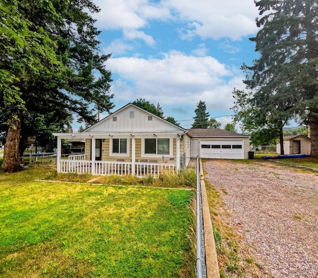 1203 1st St E, Polson, MT 59860 - view of front of property with driveway, an attached garage, board and batten siding, and covered porch