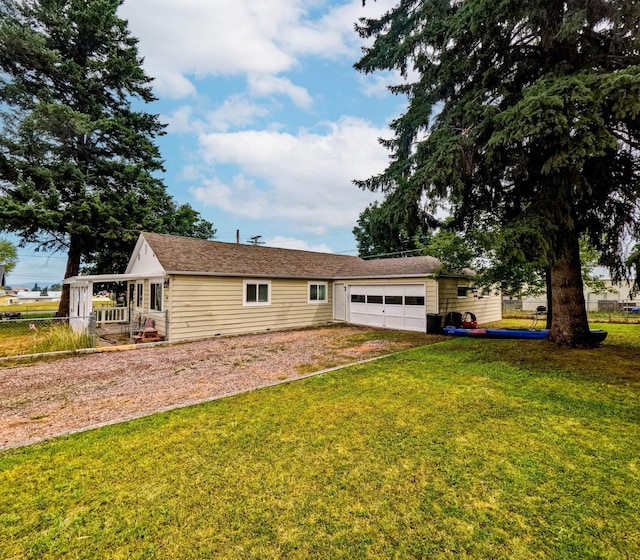 1203 1st St E, Polson, MT 59860 - back of house with dirt driveway and a garage