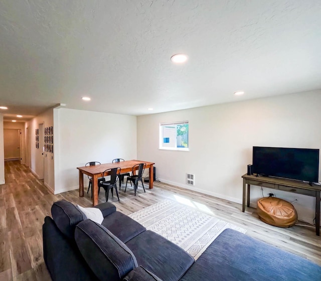 1203 1st St E, Polson, MT 59860 - living area featuring wood finished floors, baseboards, and recessed lighting