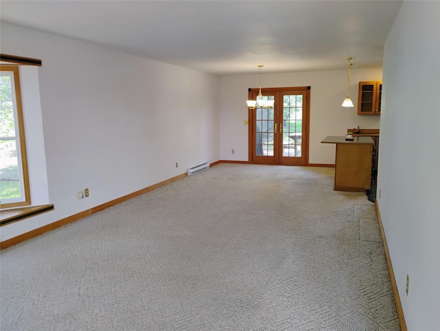 5 Pronghorn Dr, Clancy, MT 59634 - unfurnished living room with a baseboard heating unit, a chandelier, healthy amount of natural light, and light colored carpet