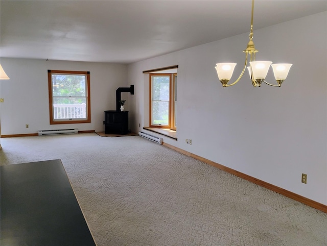 5 Pronghorn Dr, Clancy, MT 59634 - unfurnished living room with a baseboard radiator, a wood stove, carpet, and a chandelier