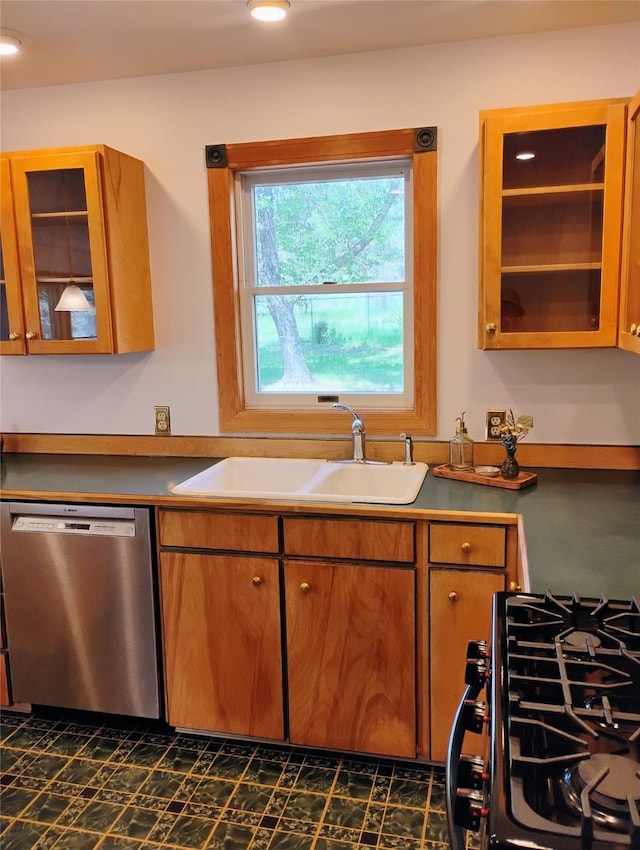 5 Pronghorn Dr, Clancy, MT 59634 - kitchen with dishwasher, range with gas stovetop, glass insert cabinets, and brown cabinetry