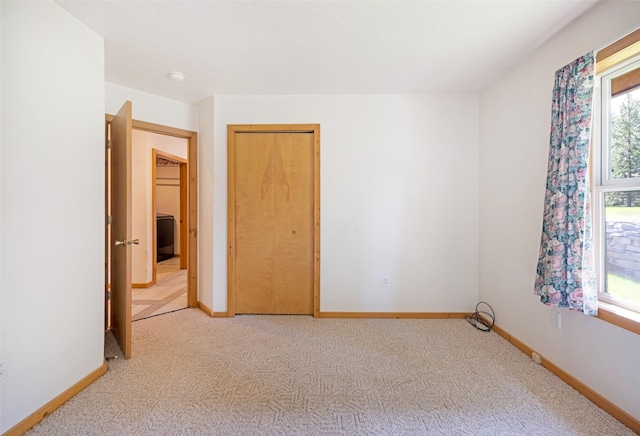 1065 Evergreen Dr, Seeley Lake, MT 59868 - unfurnished bedroom with multiple windows, light colored carpet, and a closet