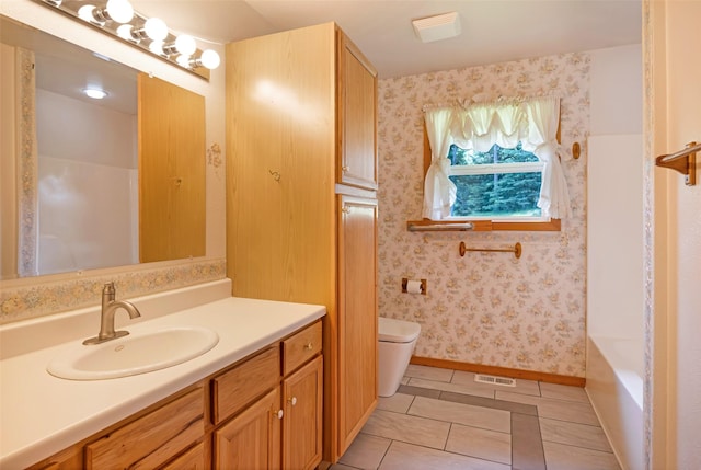 1065 Evergreen Dr, Seeley Lake, MT 59868 - full bathroom with vanity, tile patterned floors, toilet, baseboards, and wallpapered walls