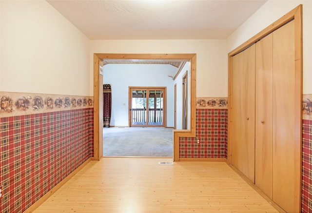 1065 Evergreen Dr, Seeley Lake, MT 59868 - corridor featuring wainscoting and light wood-style flooring
