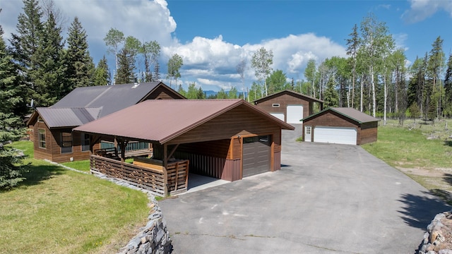 1065 Evergreen Dr, Seeley Lake, MT 59868 - rustic home with a garage, a front yard, an outbuilding, and metal roof