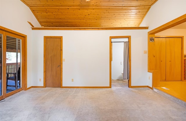 1065 Evergreen Dr, Seeley Lake, MT 59868 - carpeted spare room with wood ceiling, vaulted ceiling, and baseboards