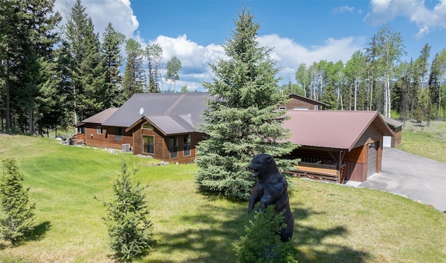 1065 Evergreen Dr, Seeley Lake, MT 59868 - view of front of home featuring a front yard, a detached garage, and metal roof