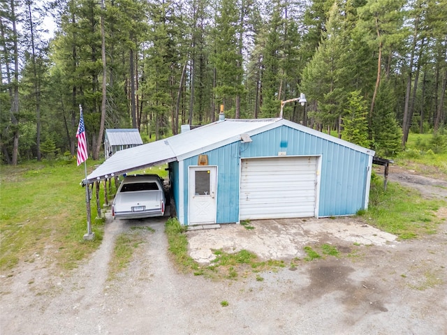 137 Amber Rd, Troy, MT 59935 - garage with a detached garage, driveway, and a view of trees