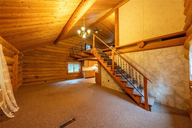 137 Amber Rd, Troy, MT 59935 - staircase with rustic walls, a chandelier, wood ceiling with exposed beams, carpet flooring, and high vaulted ceiling