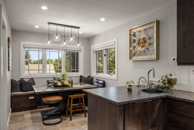 309 Fairway Dr, Whitefish, MT 59937 - kitchen featuring breakfast area, dark countertops, plenty of natural light, dark brown cabinetry, and recessed lighting