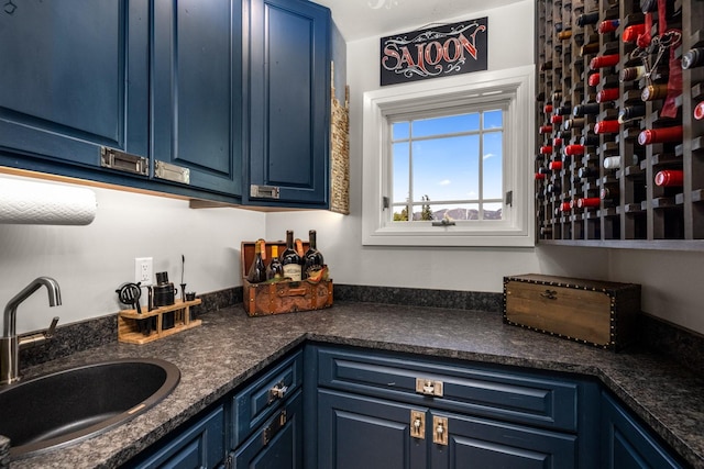 309 Fairway Dr, Whitefish, MT 59937 - kitchen with blue cabinetry and dark countertops