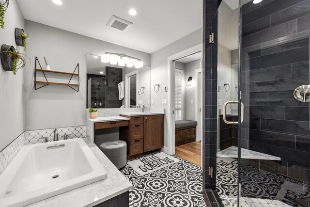 309 Fairway Dr, Whitefish, MT 59937 - full bath with a stall shower, vanity, a garden tub, recessed lighting, and tile patterned flooring