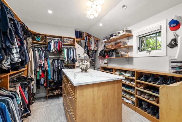 309 Fairway Dr, Whitefish, MT 59937 - walk in closet featuring lofted ceiling and a chandelier