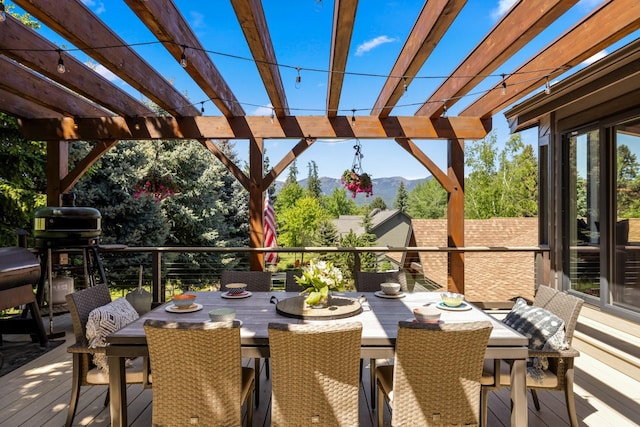 309 Fairway Dr, Whitefish, MT 59937 - deck featuring a mountain view, a pergola, and outdoor dining area