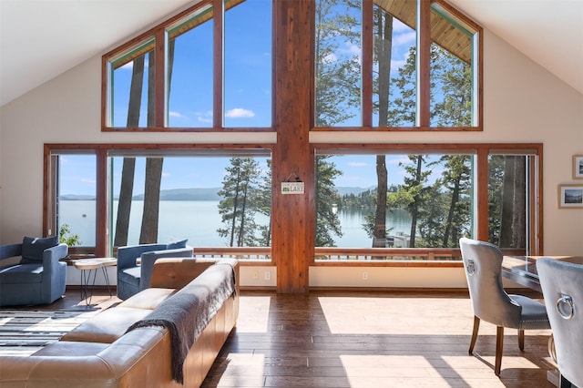 14690 Shore Acres Dr, Bigfork, MT 59911 - living room featuring high vaulted ceiling, a water view, plenty of natural light, and wood-type flooring
