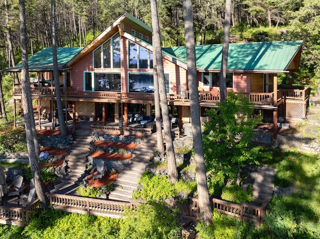 14690 Shore Acres Dr, Bigfork, MT 59911 - rear view of house featuring a wooden deck, metal roof, and stairway