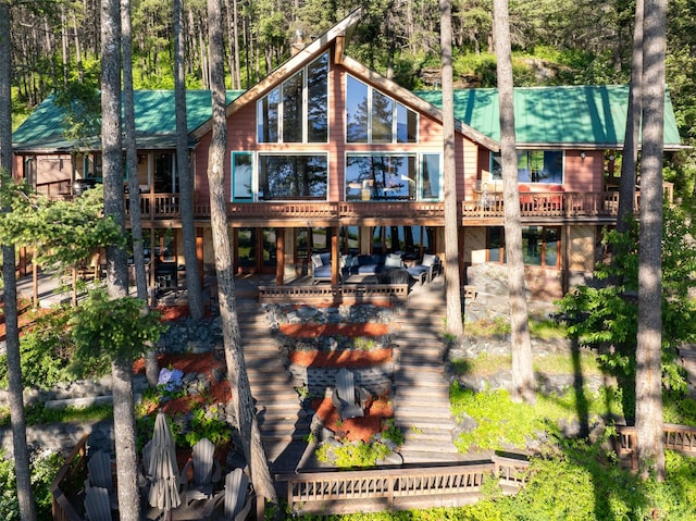 14690 Shore Acres Dr, Bigfork, MT 59911 - back of property featuring stairway, a patio, and a deck
