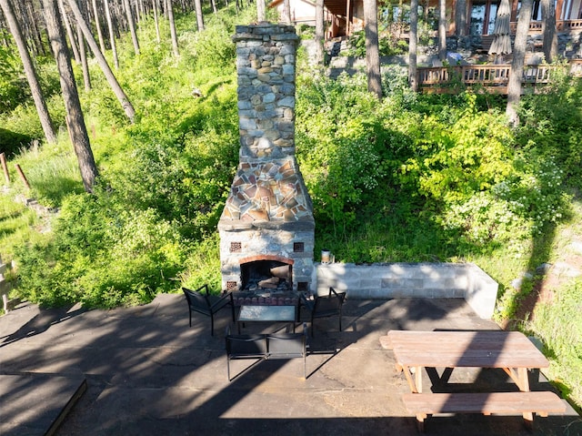 14690 Shore Acres Dr, Bigfork, MT 59911 - view of patio / terrace featuring an outdoor stone fireplace