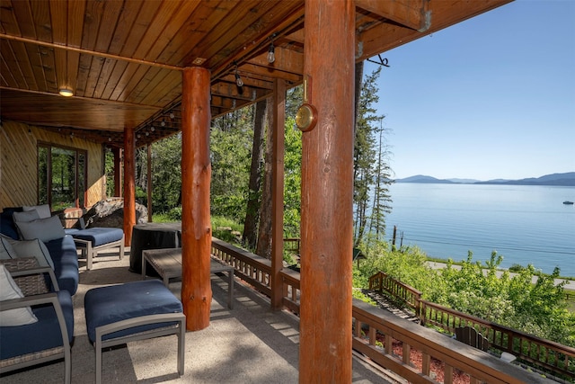 14690 Shore Acres Dr, Bigfork, MT 59911 - view of patio featuring a water and mountain view
