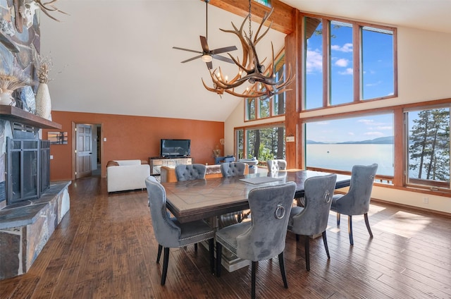 14690 Shore Acres Dr, Bigfork, MT 59911 - dining room with high vaulted ceiling, a chandelier, hardwood / wood-style floors, a fireplace, and beam ceiling