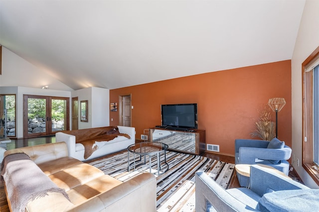 14690 Shore Acres Dr, Bigfork, MT 59911 - living area featuring wood finished floors, baseboards, and high vaulted ceiling