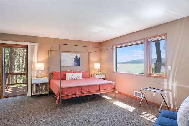 14690 Shore Acres Dr, Bigfork, MT 59911 - bedroom with carpet floors, baseboards, and access to outside