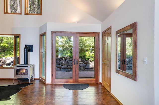 14690 Shore Acres Dr, Bigfork, MT 59911 - entryway with french doors, a wood stove, dark wood finished floors, high vaulted ceiling, and baseboards