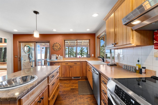 14690 Shore Acres Dr, Bigfork, MT 59911 - kitchen featuring stainless steel appliances, wall chimney range hood, a sink, dark wood-type flooring, and recessed lighting