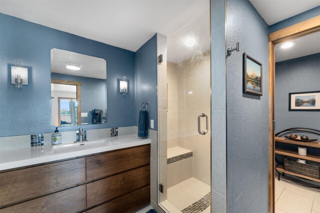 14690 Shore Acres Dr, Bigfork, MT 59911 - full bathroom featuring a textured wall, vanity, and a shower stall