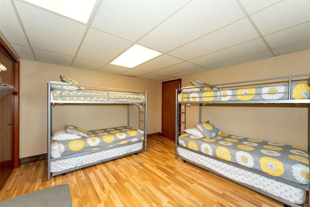 14690 Shore Acres Dr, Bigfork, MT 59911 - bedroom with a drop ceiling, wood finished floors, and baseboards