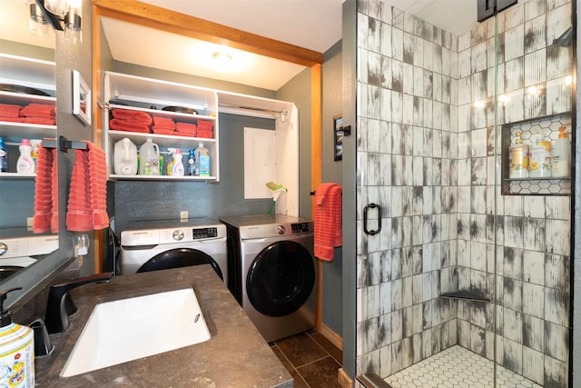 14690 Shore Acres Dr, Bigfork, MT 59911 - laundry room featuring washing machine and dryer and dark tile patterned floors