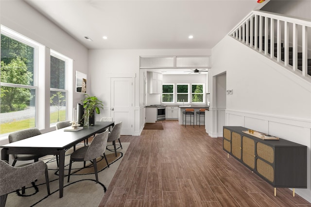 189 Blue Creek Rd, Heron, MT 59844 - dining space with dark wood-style flooring, a ceiling fan, wainscoting, and recessed lighting