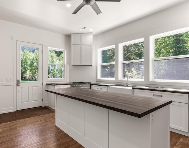 189 Blue Creek Rd, Heron, MT 59844 - kitchen with wooden counters, a sink, dark wood finished floors, ceiling fan, and a center island