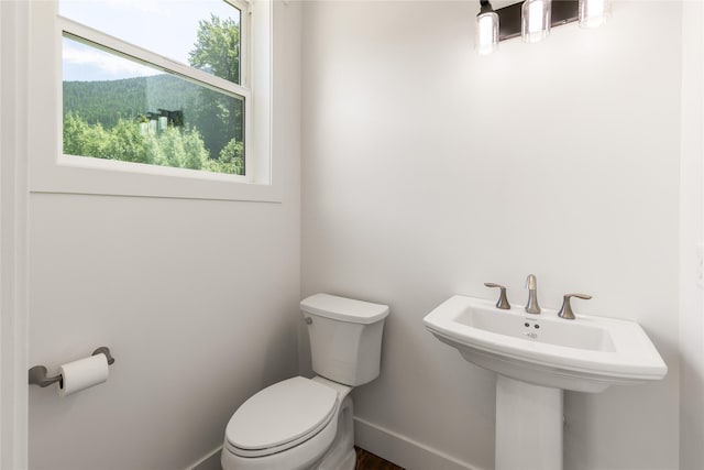 189 Blue Creek Rd, Heron, MT 59844 - bathroom featuring toilet, baseboards, and a sink