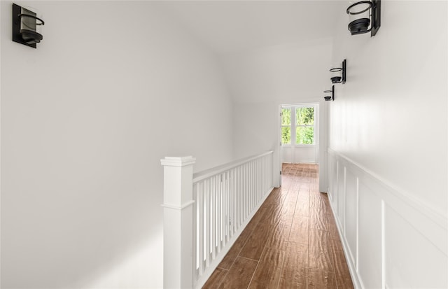 189 Blue Creek Rd, Heron, MT 59844 - corridor featuring wood finished floors, wainscoting, a decorative wall, and an upstairs landing